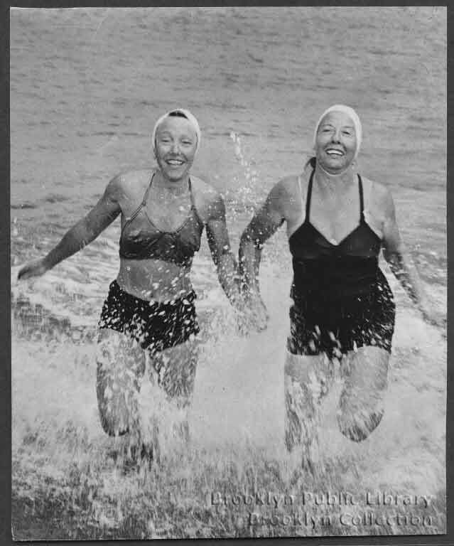 two women spalsh in the surf at coney island in 1948