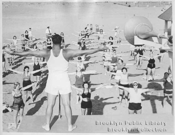 people workout on the coney island beach in the 1950s