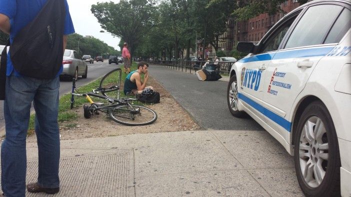 A bicyclist sits on the ground following a crash on Ocean Parkway, near Cortelyou Road, last year. Photo by Je Suis
