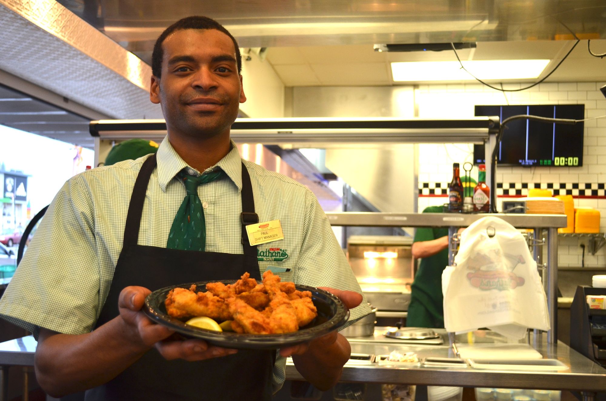 Shift Manager Paul Harris holding a plate of frog legs