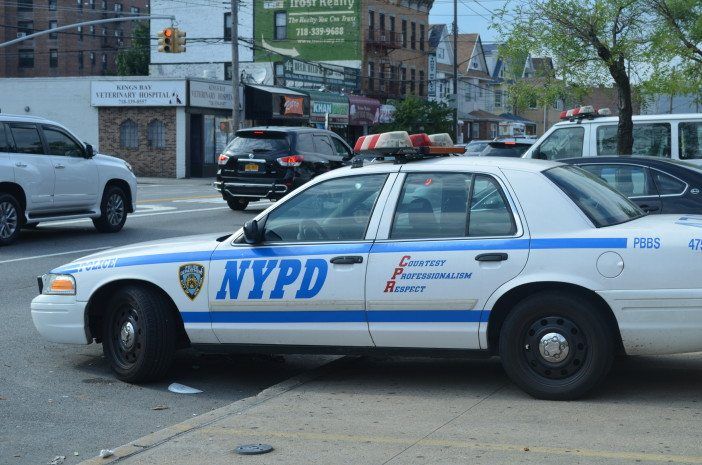 A police cruiser parked outside the 61st precinct.