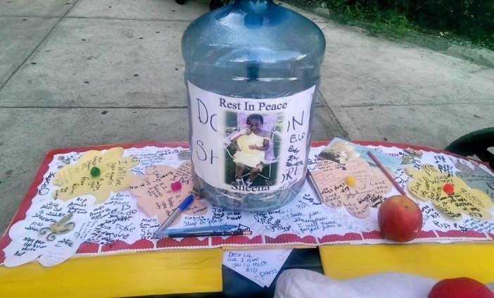 A jar for donations for Jadann's family is set atop notes remembering the young girl. (Photo by Shannon Geis/Ditmas Park Corner) 