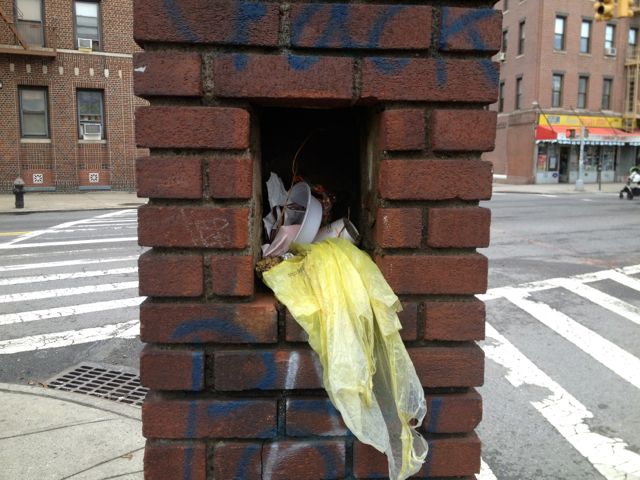 One of the demolished stanchions, pictured in 2013, with litter stuffed into a cut-out in the column, and graffiti on the bricks. 