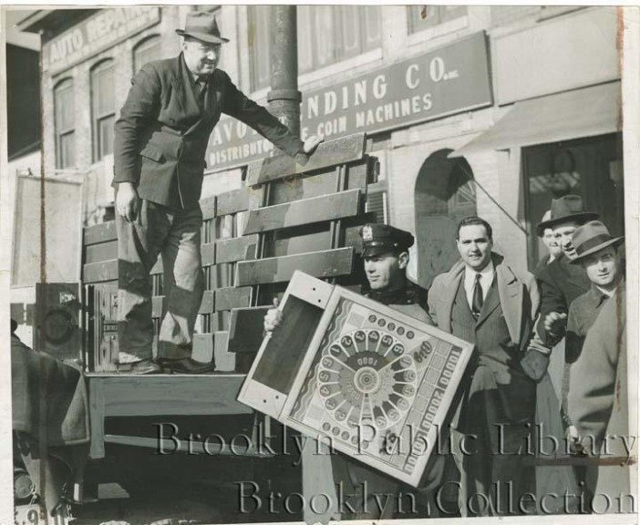 old photo of cops confiscating pinball machines