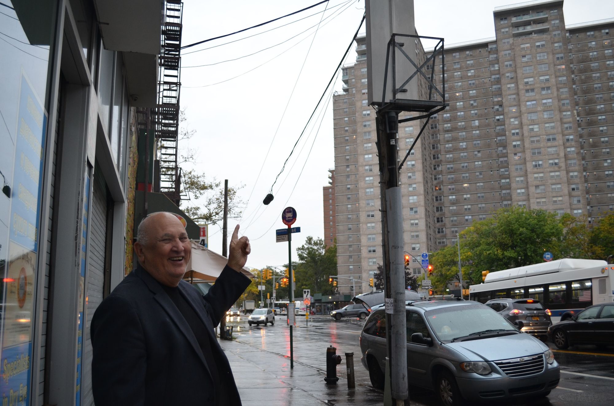 Sam Bykov pointing to a post where he would like the city to install a street light. 