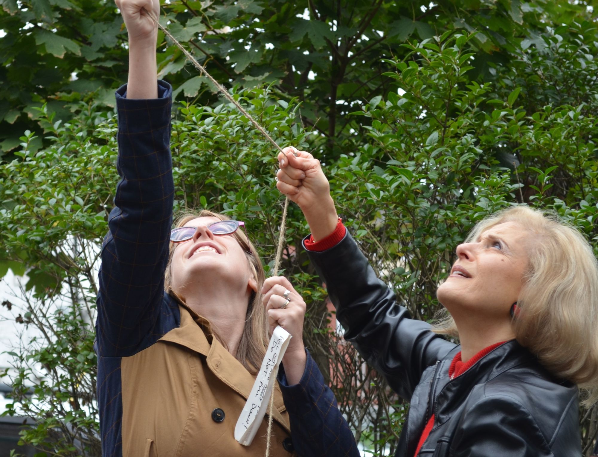 Terra and Linda pulling the cover off the new street sign.