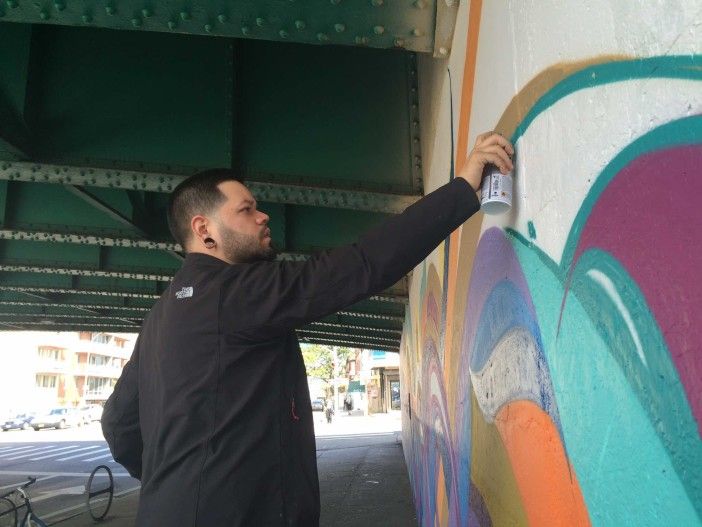 Mural Artist Miguel Del Real creating "Intersections"