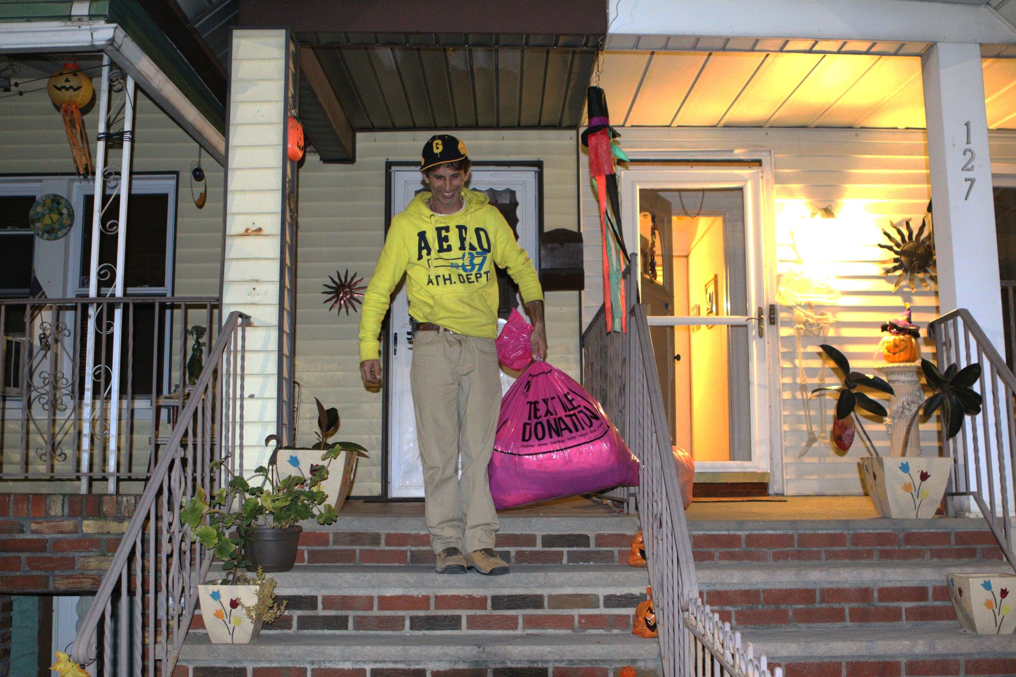 Nicky Nguyen leaves pink bag of used clothing on the curb. (Photo by Camila Cibils)