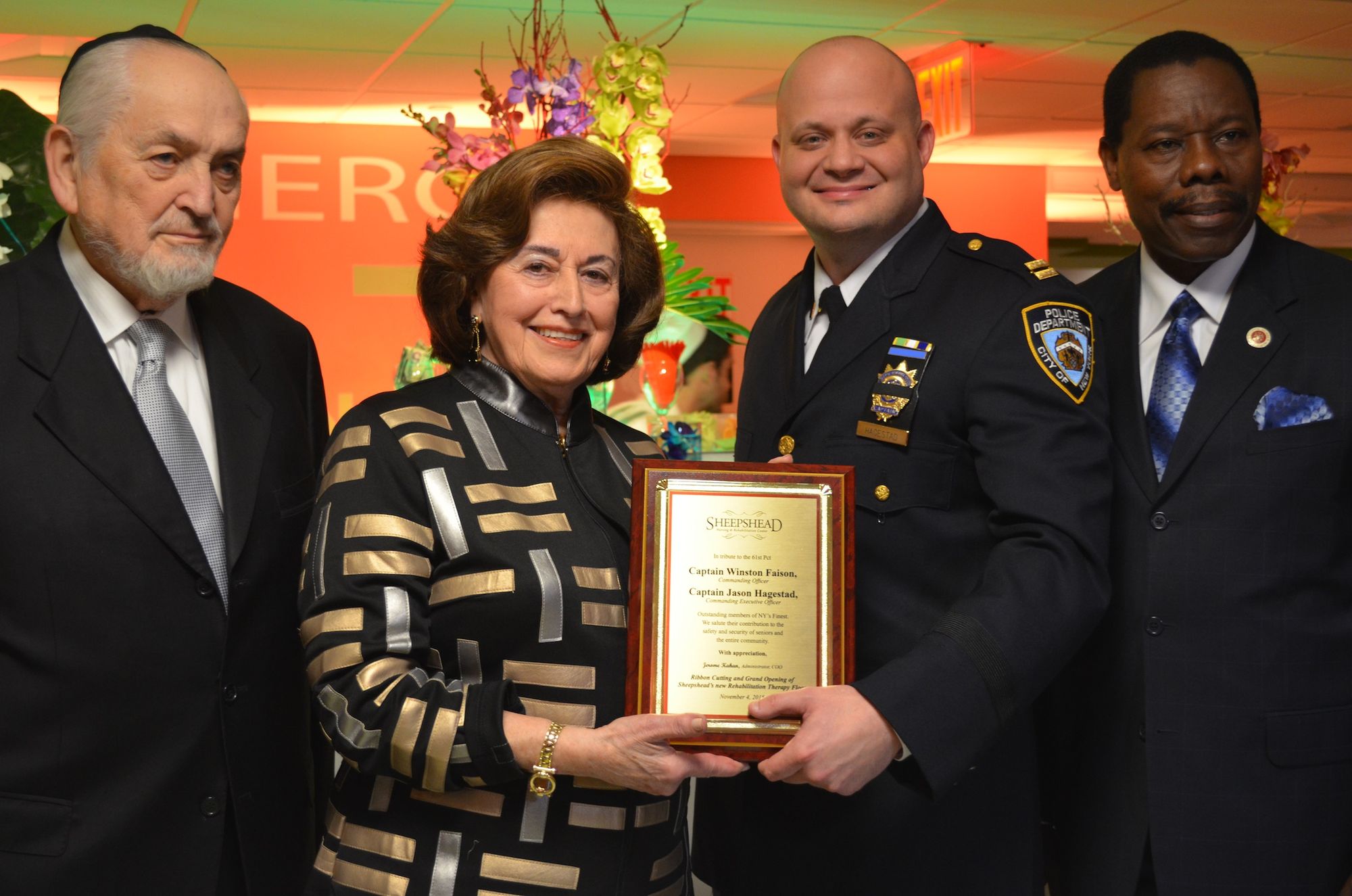 Owner Olga Lipschiptz (Center left) standing beside her partner Sam Pameth. Captain Jason Hagestad of the 61st Precinct (Center right) and City Councilman Mathieu Eugene. 