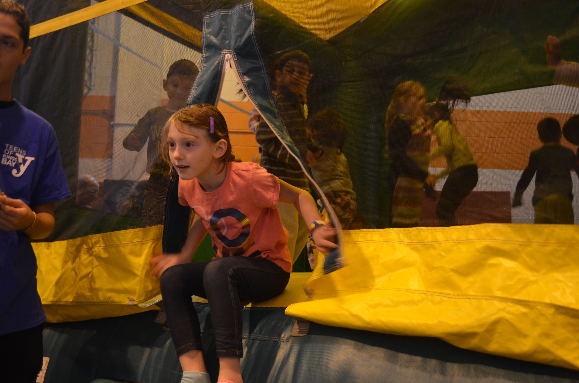 Kids were leaping in and out of the bouncy castle. 