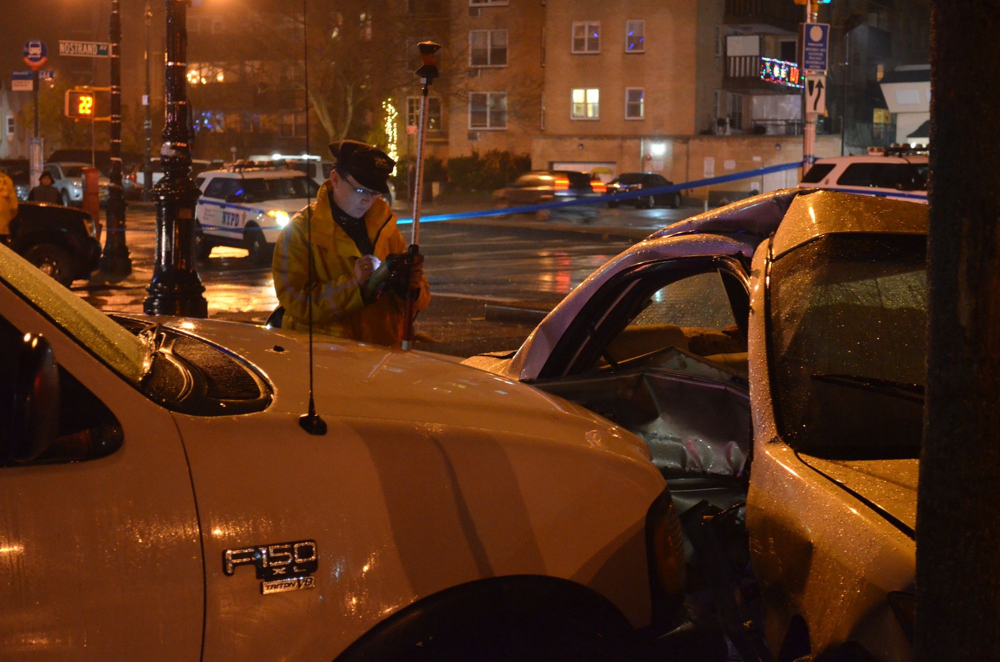 A police investigator taking notes on the position of the Toyota Camry.