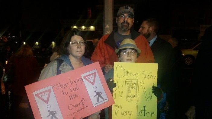 Grace Freedman, David Herman, and Daniel Scuria-Herman paid their respects while calling for safer streets. (Photo by Heather Chin/Fort Greene Focus.)