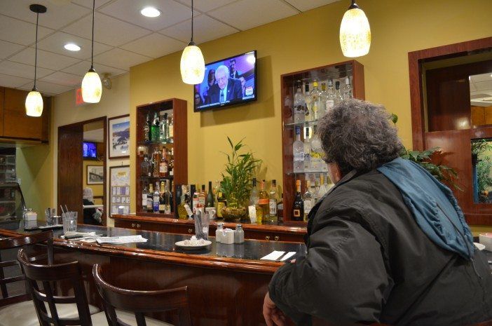 Watching the Iowa Town Hall. The man seated is not Joe. (Photo: Alex Ellefson / Sheepshead Bites)