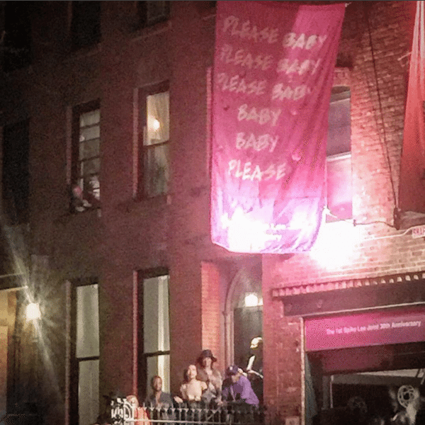 (People were hanging out the windows to be a part of Spike Lee's block party. Courtesy Justin Fox/Instagram)