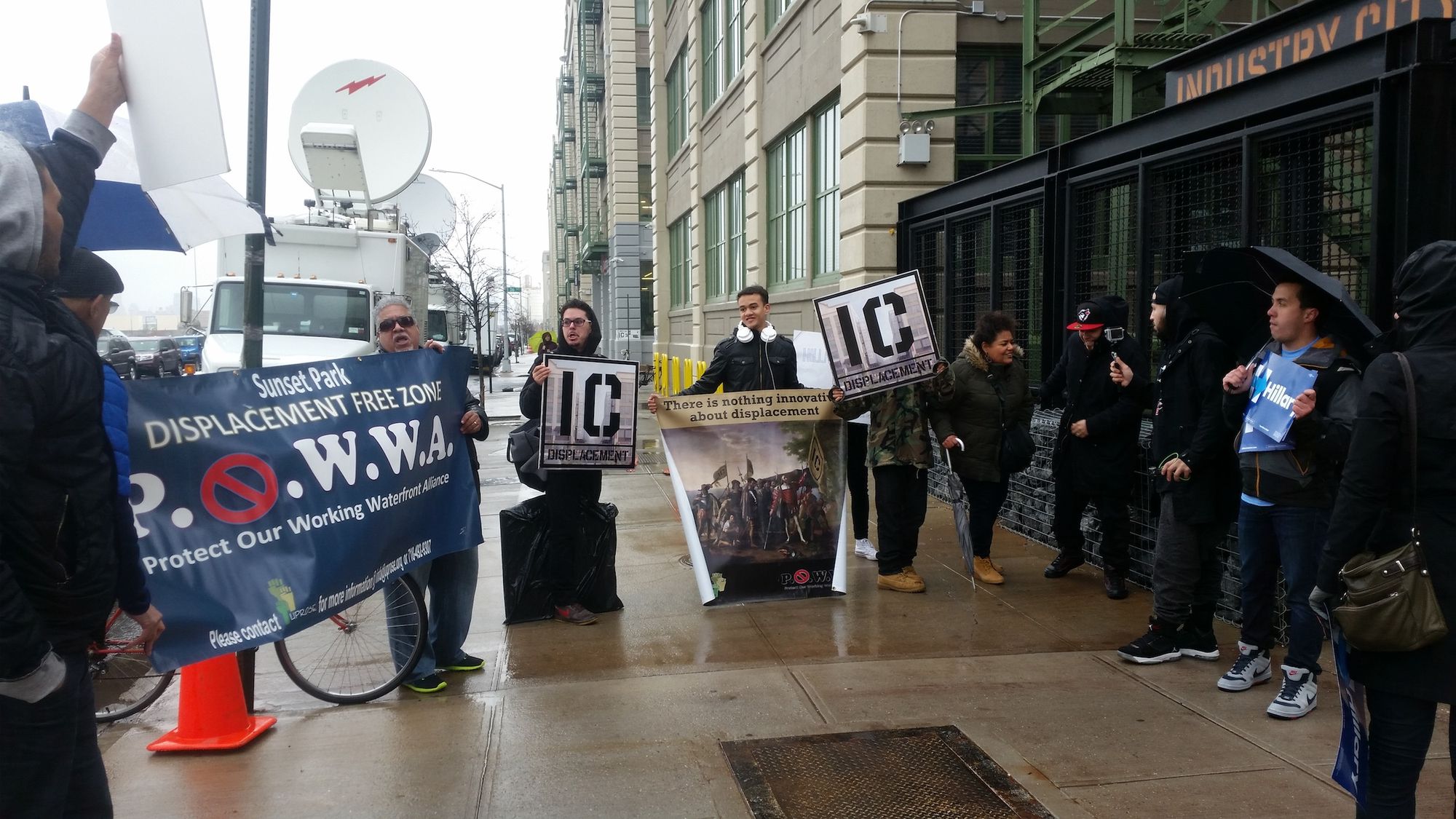 Anti-gentrification and -displacement protesters chanted as Hillary Clinton campaign volunteers stood by. (Photo by Heather Chin/Sunset Park Voice)