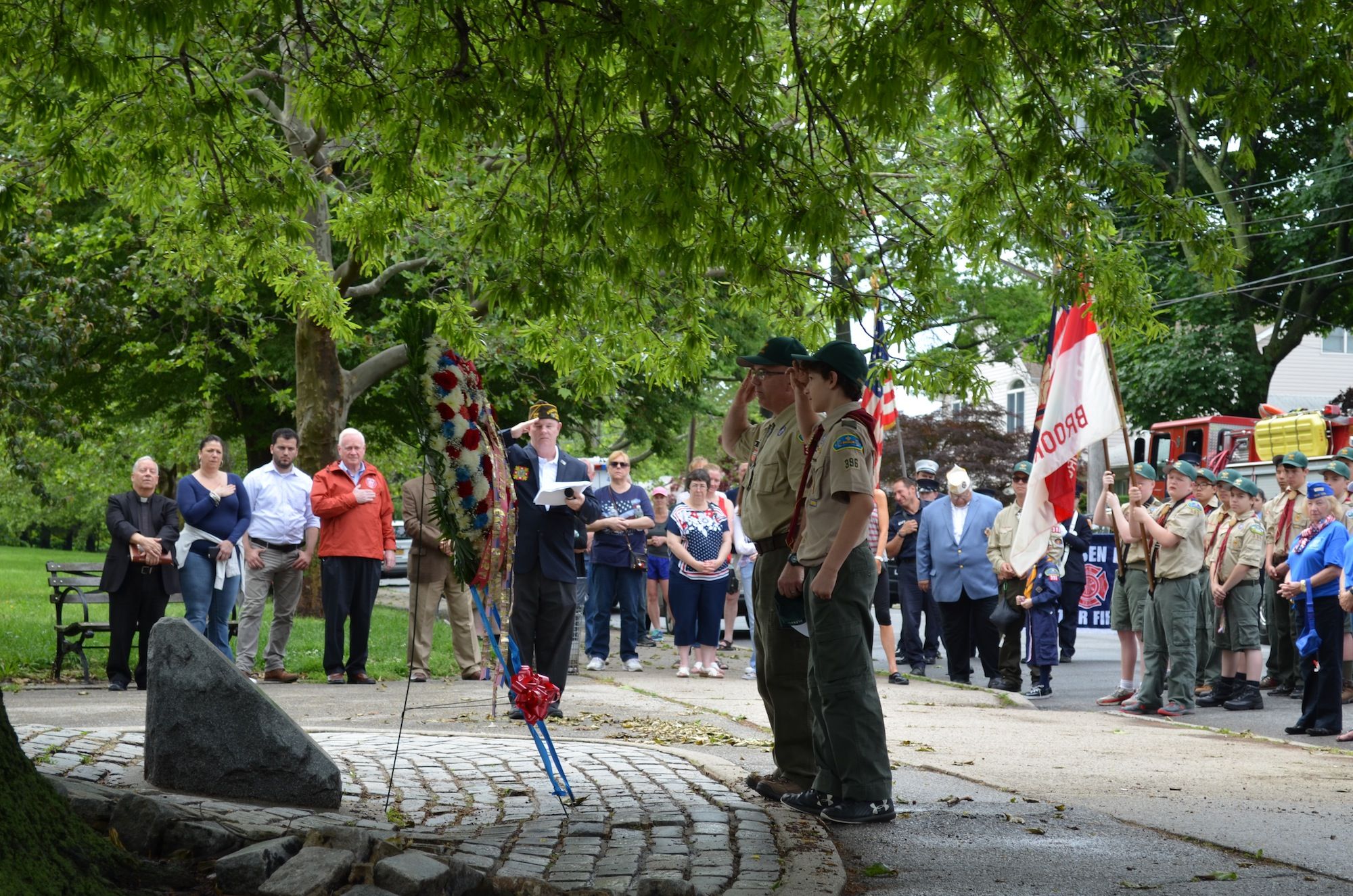 Members of Boy Scout Troop 396 salute the wreath placed in front of the veterans memorial. (Photo: Alex Ellefson / Sheepshead Bites)