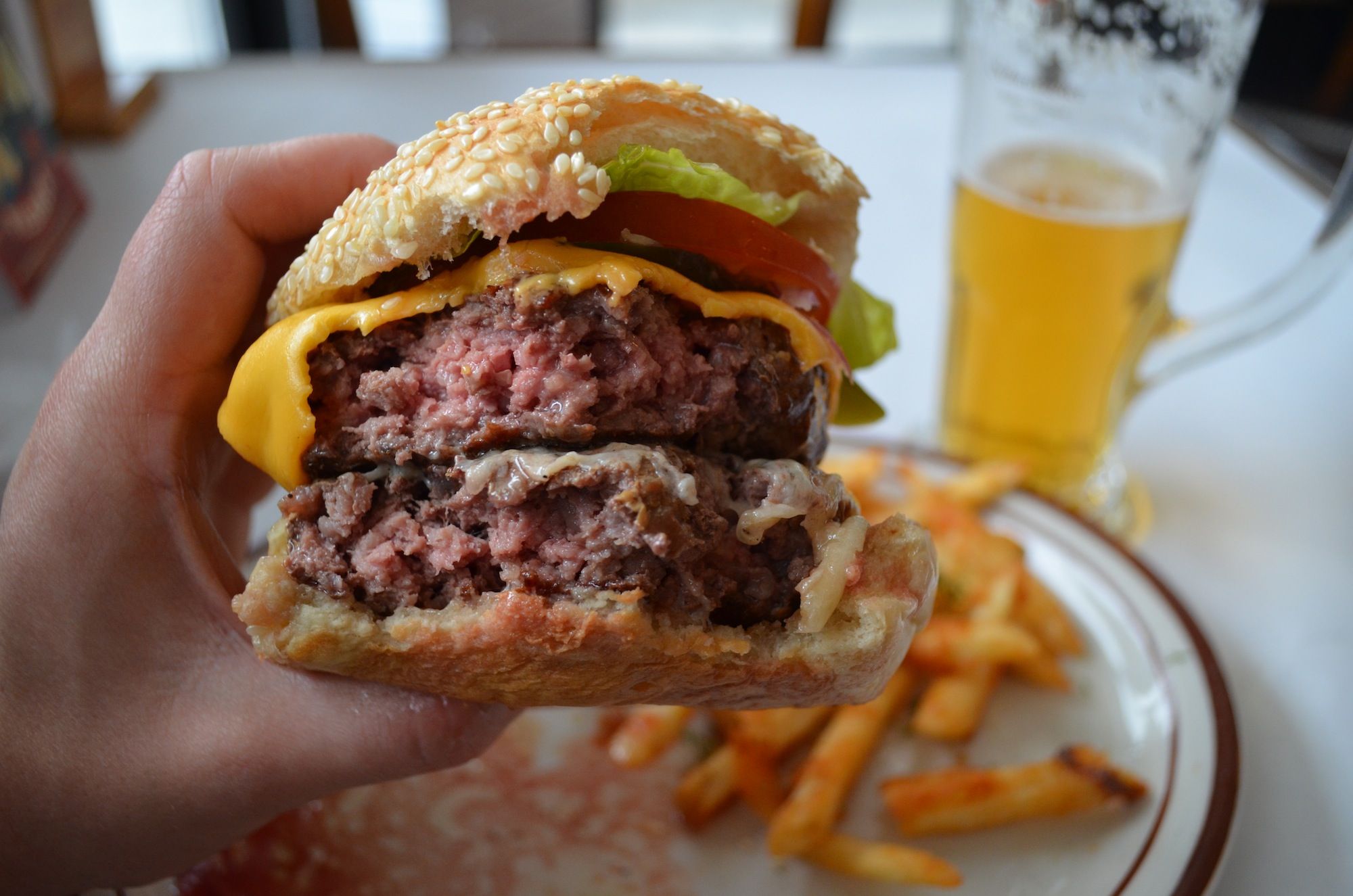 Making progress on the Juicy Lucy burger at Max Cafe. (Photo: Alex Ellefson / Sheepshead Bites)