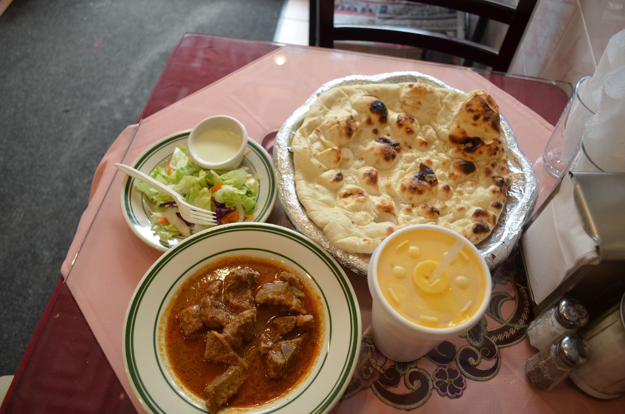 Goat curry and naan flatbread at Nasheman Grill & Restaurant. (Photo: Alex Ellefson / Sheepshead Bites)