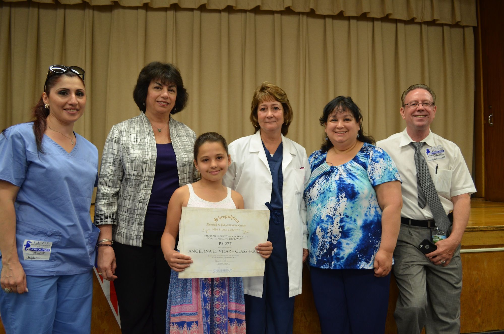 P.S. 277 4th grader Angelina Vilar, center, holding up her award. (Photo: Alex Ellefson / Sheepshead Bites)