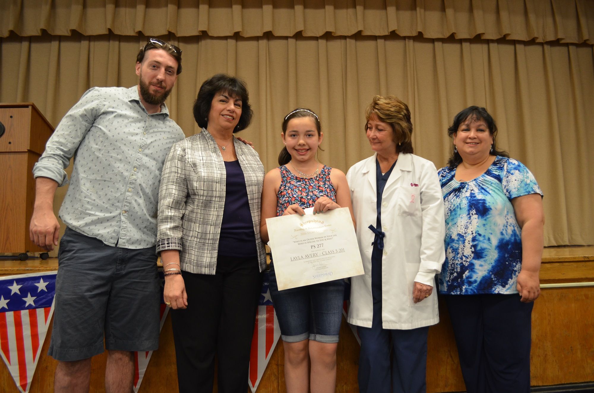 P.S. 277 5th grader Layla Avery, center, accepting her award. (Photo: Alex Ellefson / Sheepshead Bites)