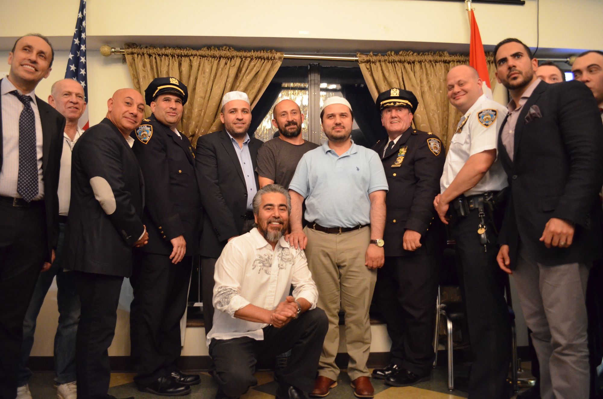 Police officers and members of the mosque standing together after the meal. (Photo: Alex Ellefson / Sheepshead Bites)