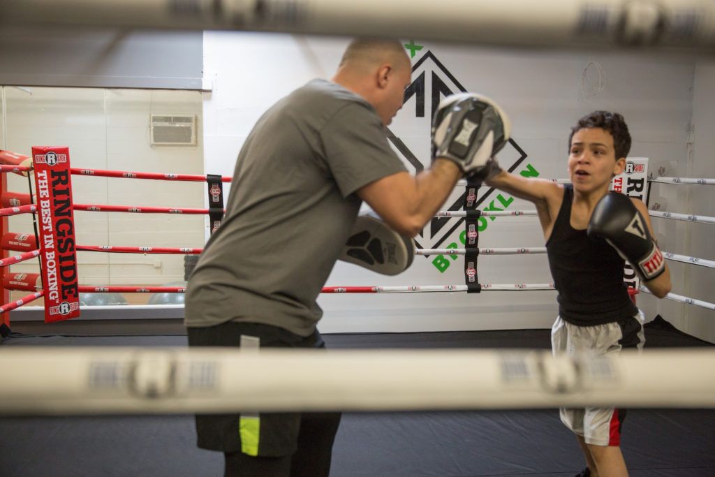 Coach Arce trains 13-year-old Manny Ruiz at Sweatbox. (Photo: Jacqueline Frias)