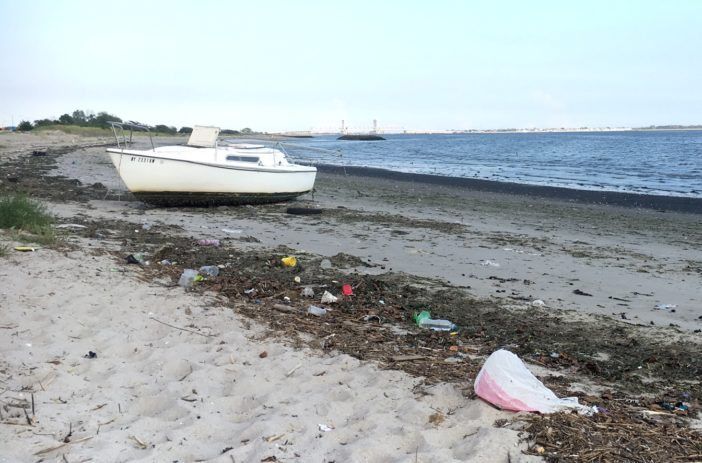 Abandoned boat amidst the other beach debris.