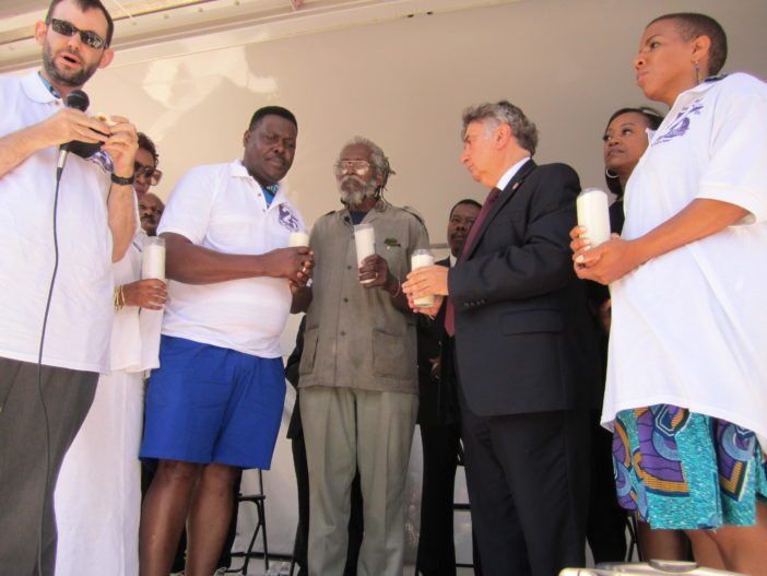 Carmel Cato lit a candle in his son's honor. (Photo: Elizabeth Elizalde / Fort Greene Focus) 