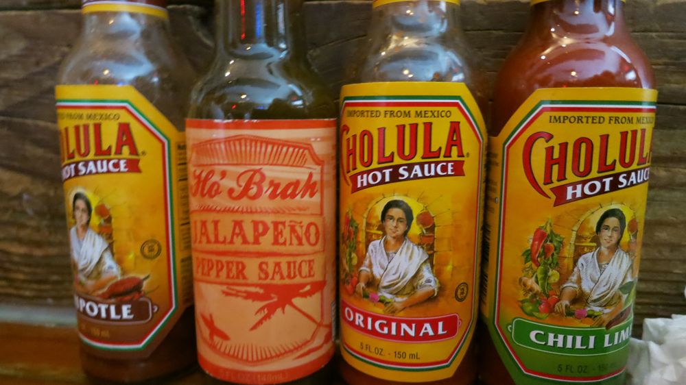 Our table's hot sauce selection. Photo by Hannah Frishberg