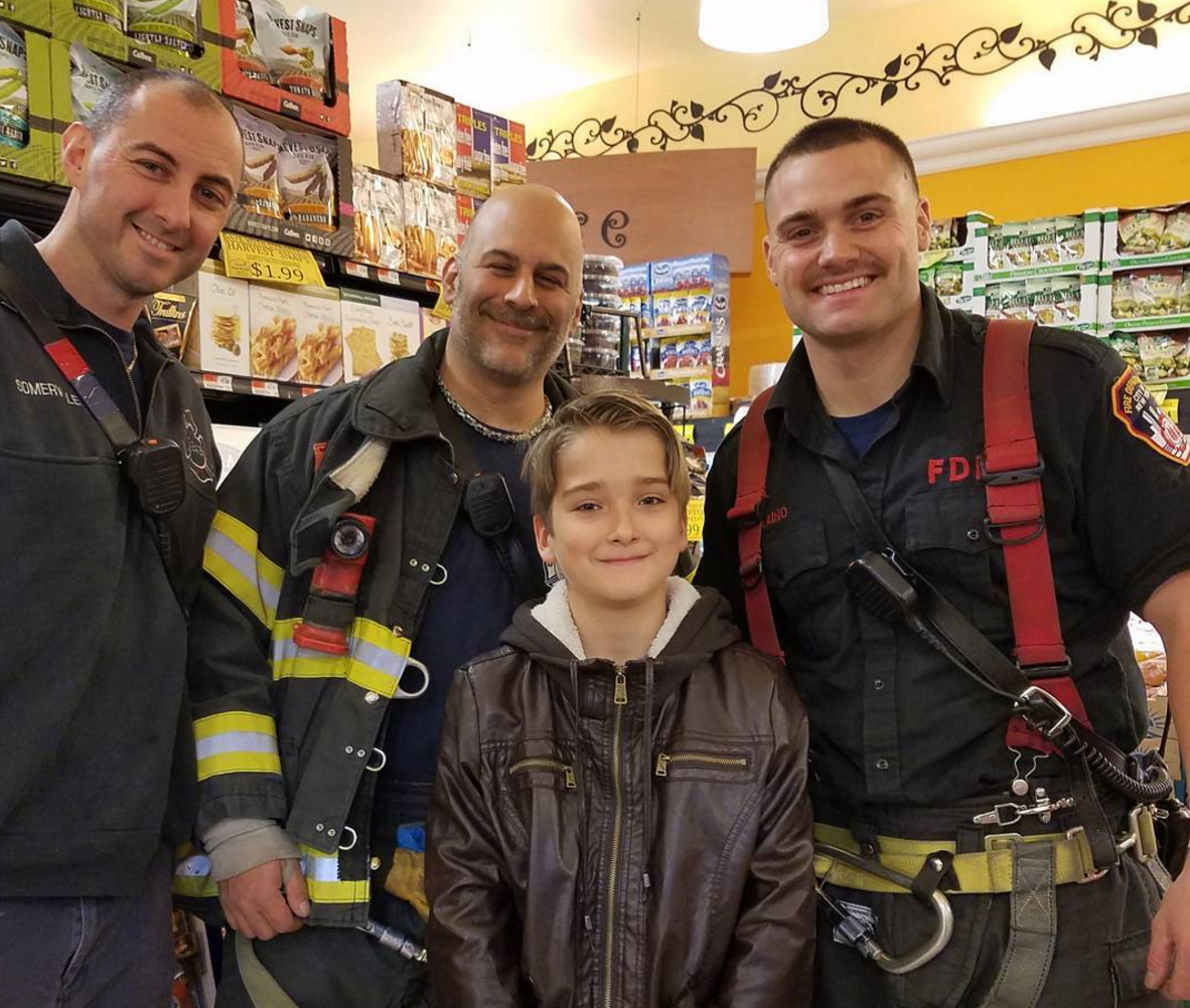 Happy Veterans Day! Here, firefighters pose with a young admirer in Dyker Heights. Photo by yodalovesgracie