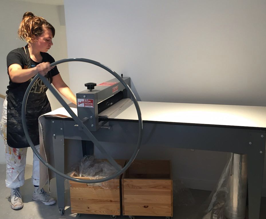 Student Kate Klingbeil using the slab roller