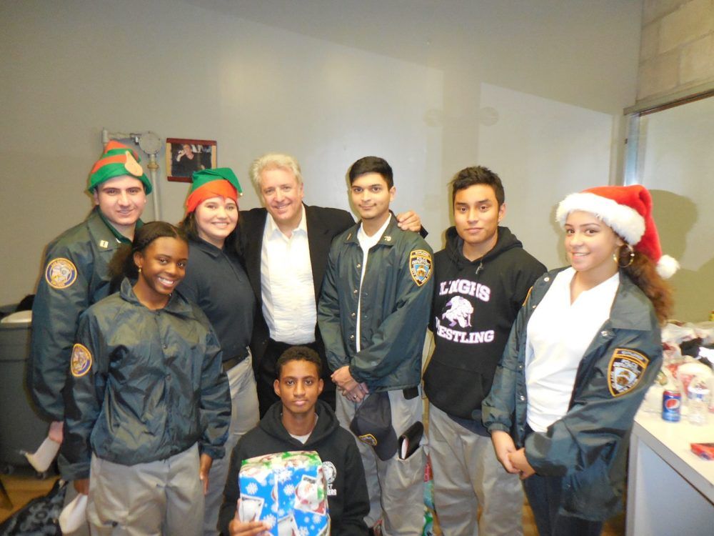 The 70th precinct Explorers, who scrambled to get additional chairs, wrap presents, and help the magician manage the crowd until Santa arrived. (Photo by Nathan Thompson) 