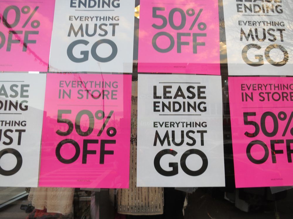 The windows are covered in wall to wall sale signs. (Photo by Hannah Frishberg / Bensonhurst Bean)